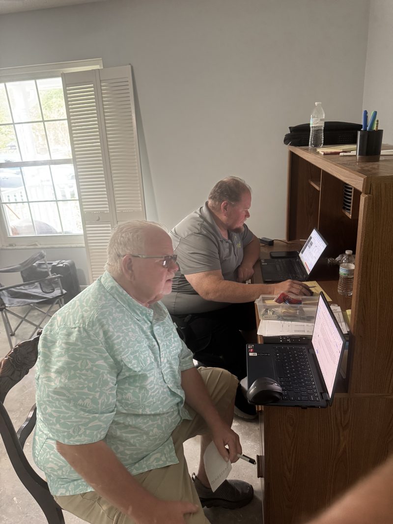 Mike going through the numbers with a homeowner at their kitchen desk