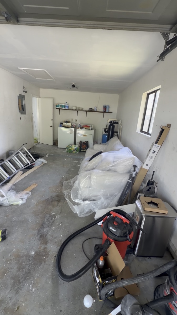 Garage staged for the work: materials and tools on site, ready to go