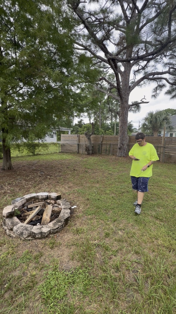 The yard: mature trees and a fire pit out back