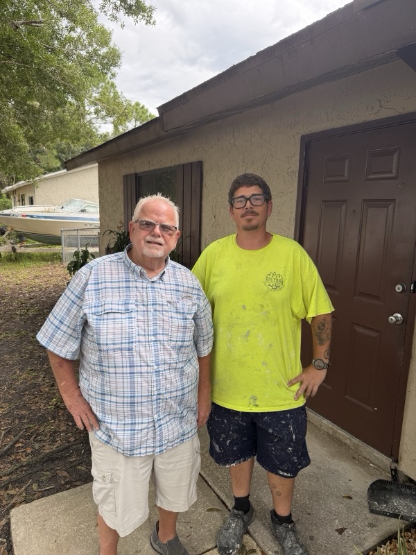 The Brevard Buyers Group crew by a freshly painted front door